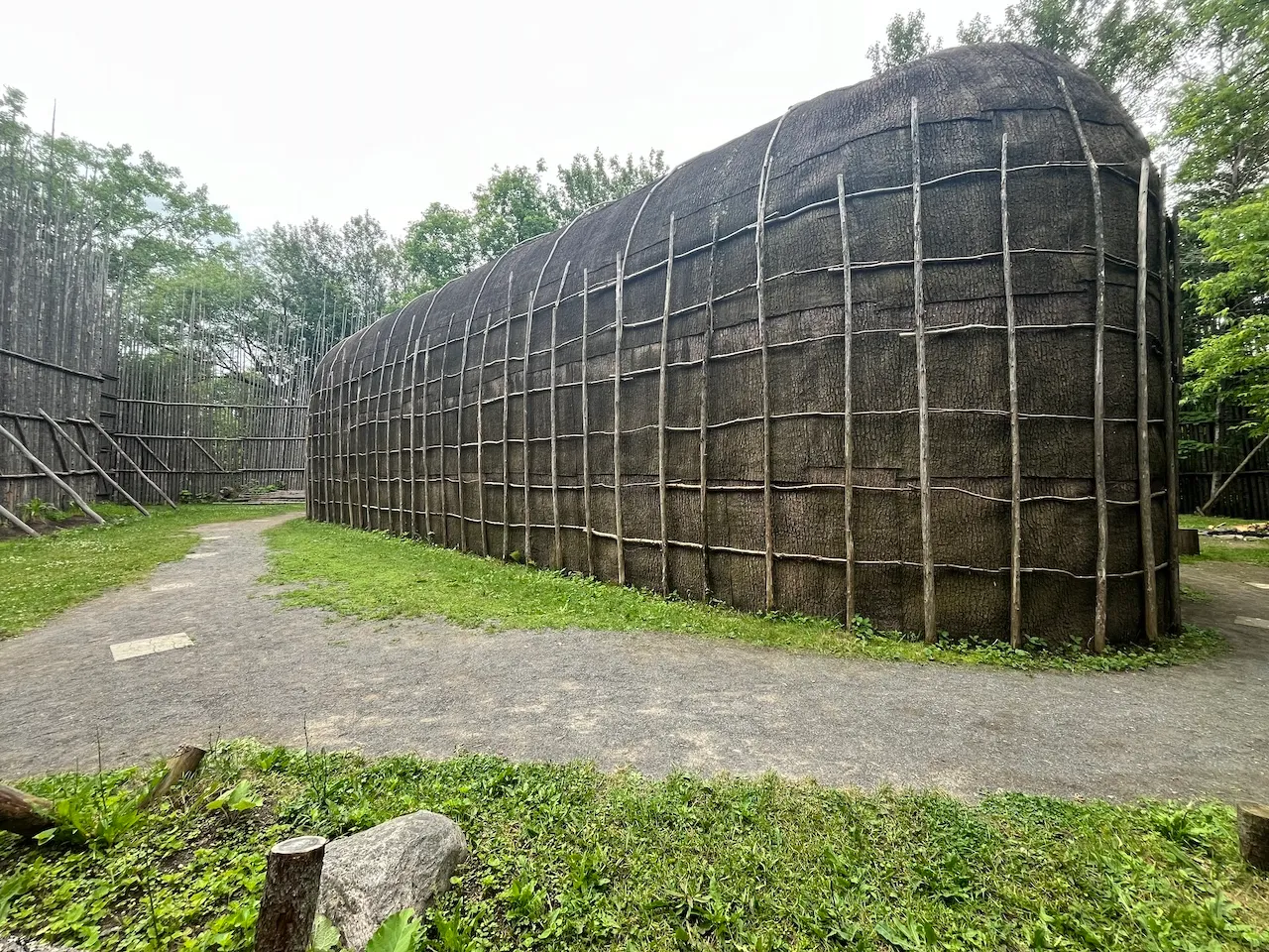 Ekionkiestha' National Longhouse - exterior - compacted rock dust path