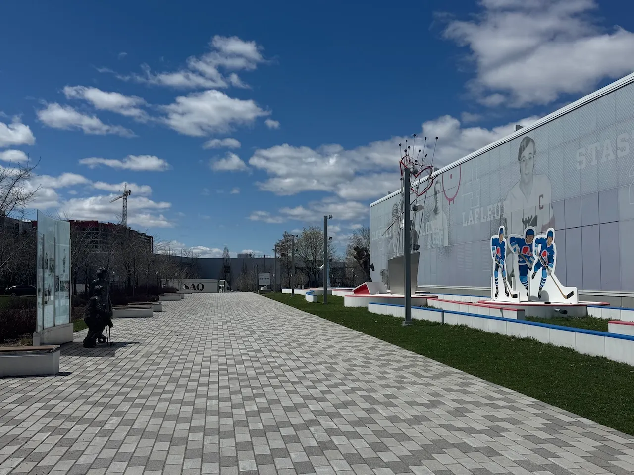 Walkway lined with benches and artwork